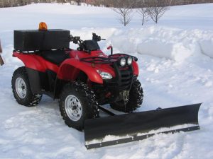 Honda ATV with snow plow attached