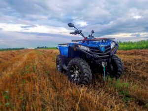 An ATV sits in an empty field