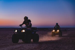 Two atvs riding during sunset